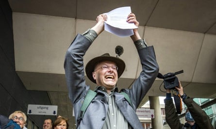 Director of Dutch environment organisation ‘Milieudefensie’ Donald Pols reacts as he walks outside a court in The Hague.