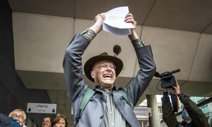 Director of Dutch environment organisation ‘Milieudefensie’ Donald Pols reacts as he walks outside a court in The Hague.