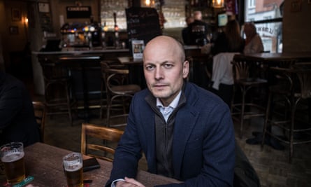 Georg Riekeles sitting at a table in a bar.
