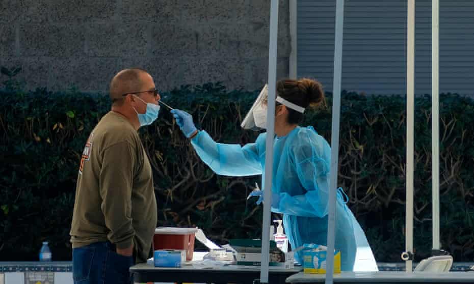 A health worker collects nasal swab samples in Los Angeles.