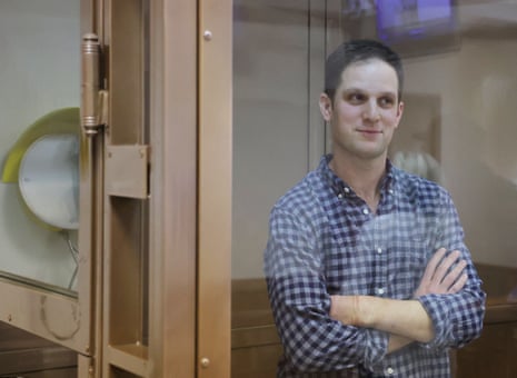 Wall Street Journal reporter Evan Gershkovich, who was detained in March while on a reporting trip stands behind a glass wall of an enclosure for defendants before a court hearing to consider an appeal against his detention, in Moscow.