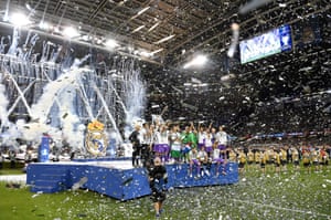 The Real Madrid team celebrate with the trophy.