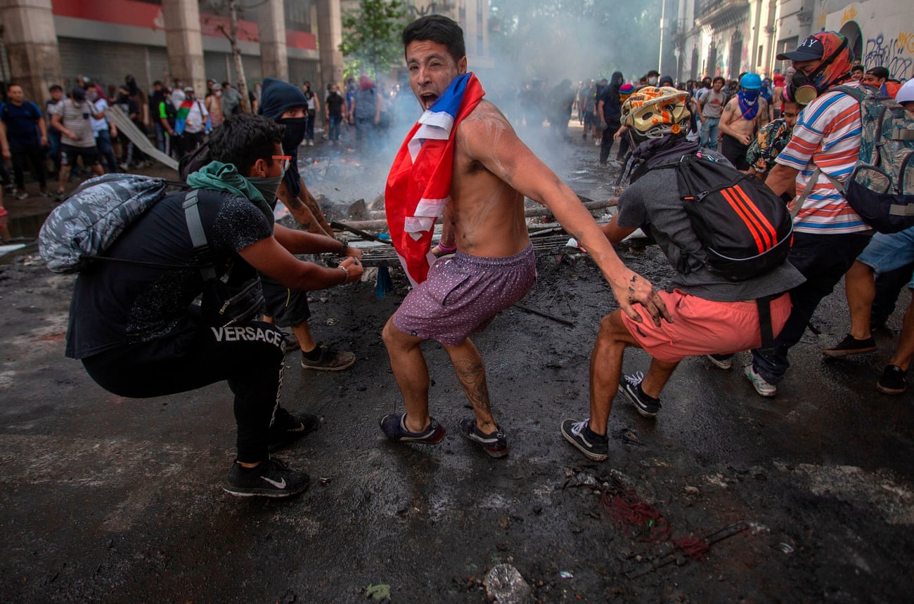 Demonstrators clash with riot police in Santiago, Chile