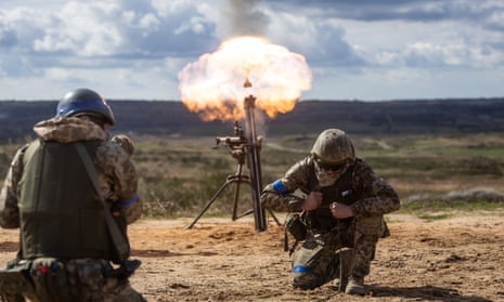 Ukrainian soldiers fire a mortar during military training exercise.