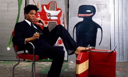 Jean-Michel Basquiat poses with his art in 1985.