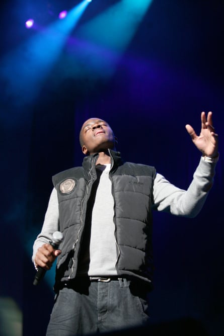 Guvna B closes his eyes while performing on stage