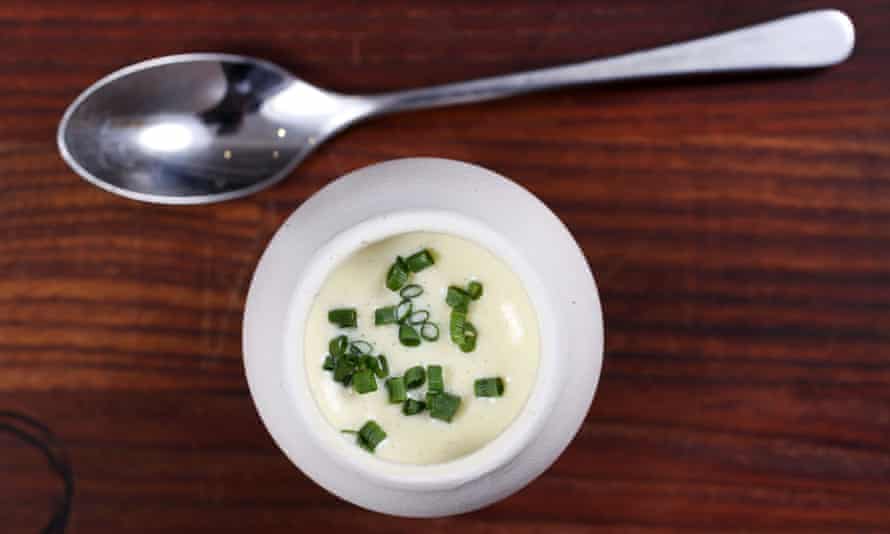 Egg, cheddar and sherry, a cream-colooured mousse in a round white dish with chopped chives on top