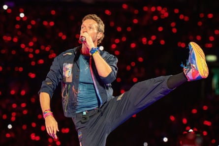 Chris Martin sings while performing a high kick