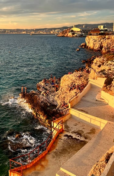 Marseille, France ‘Marseillais and tourists enjoy sunset on the rocks behind what used to be a private beach.’