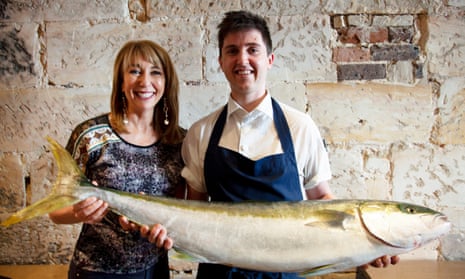 Chef Josh Niland holding kingfish with Food Safari host Maeve O’Meara