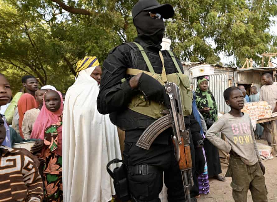 A Nigerien police officer stands guard at a market near the Diffa airport. Under the constant threat of Boko Haram, the large city on the border with Nigeria lives in a state of siege.