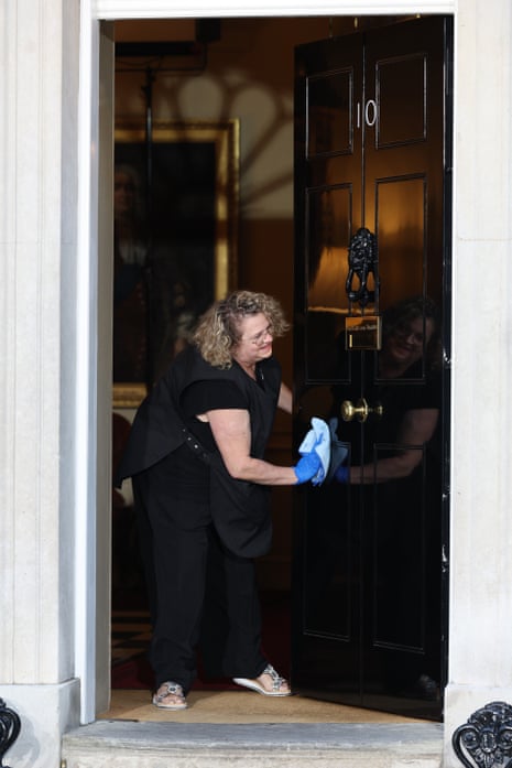 A woman cleaning the door at No 10 this morning.