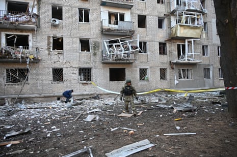 A rescuer works outside a residential building damaged as a result of Russian strikes in Kharkiv on Wednesday.