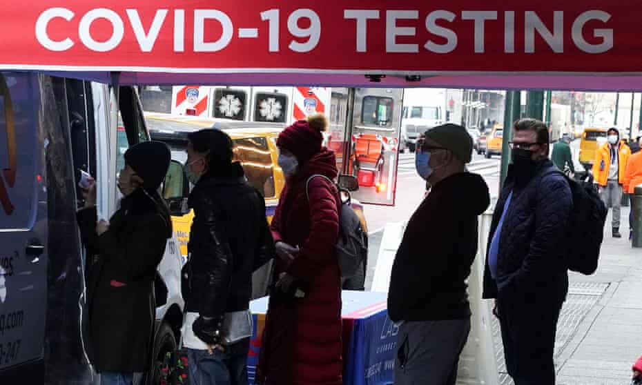 People in winter wear line up for Covid-19 testing in New York City.