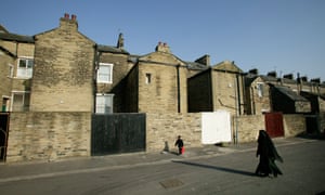 A woman and boy walking in the Manningham district of Bradford