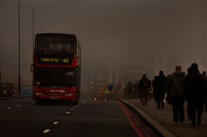 Commuters and busy traffic on London Bridge on a smoggy morningCommuters and busy traffic crossing London Bridge on a smoggy morning, 15 March 2012