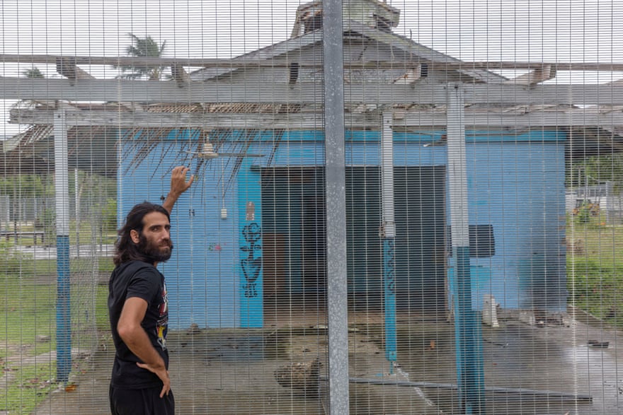 Behrouz Boochani stands outside the abandoned naval base on Manus Island where he and other asylum seekers were locked up for the first three years.