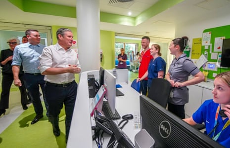Keir Starmer (white shirt) and shadow health secretary Wes Streeting (blue shirt) during a visit to Alder Hey Children's Hospital, Liverpool, this morning.