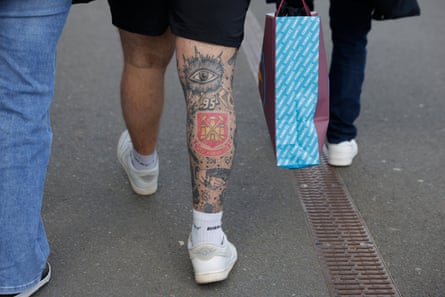 A West Ham fan with a tattoo of the club crest