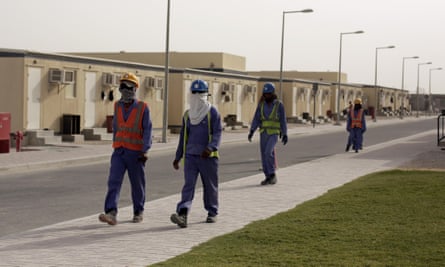 Labourers head back to their housing at the end of their workday, in Doha, Qatar