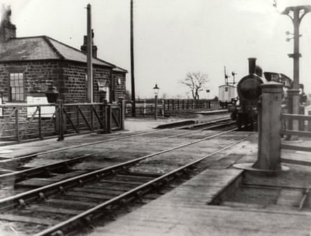 Old black and white photograph of train outside station