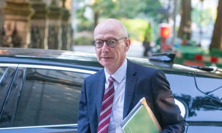 Pat McFadden getting out of a car holding a green folder under his arm