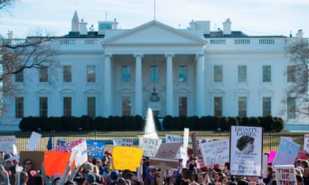 Protesters hold up a sign near the White House following the Women’s March on Washington on 20 January 2018.