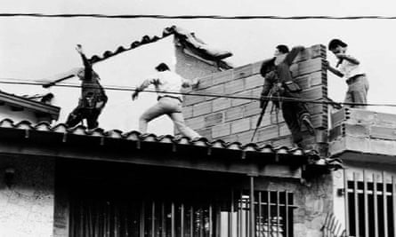 Police and military forces storm the rooftop where drug lord Pablo Escobar was shot dead in 1993.