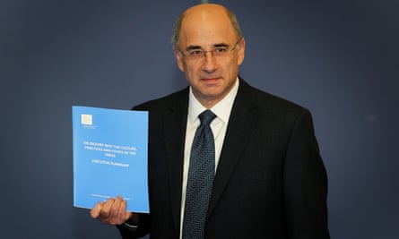 Lord Justice Leveson with the Report from the Inquiry into the Culture, Practices and Ethics of the Press in 2012.