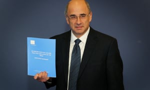 Lord Justice Leveson with a copy of his inquiry report