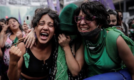 Two women wearing green look happy
