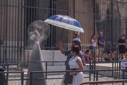 Tourists sprayed with cooling mist at the Colosseum in Rome.