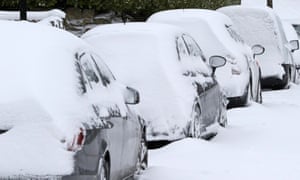 Cars covered in snow