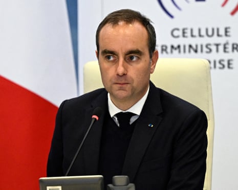 Prime minister Sébastien Lecornu sits before a microphone, glancing to the side