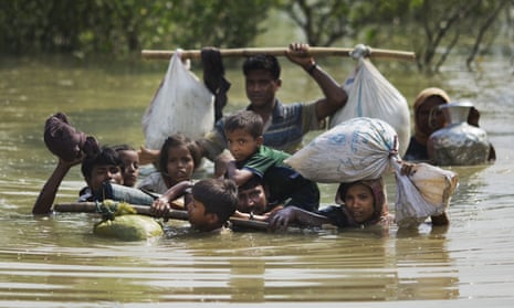 A Rohingya family reaches the Bangladesh border after crossing a creek of the Naf river