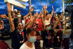 Paris Saint-Germain supporters react at a cafe terrace in Paris.