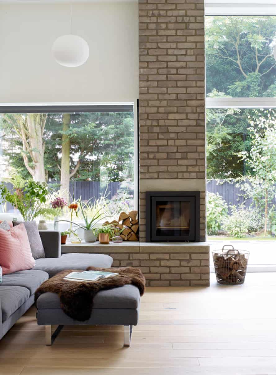 the chimney breast in the living room features the same grey bricks as the facade