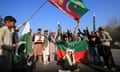 Supporters of the Pakistan Tehreek-e-Insaf party wave flags and hold banners
