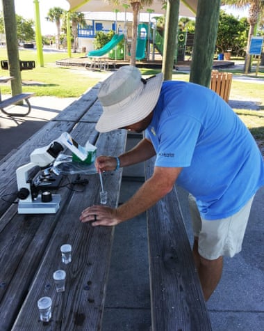 Chris Holland, an NCCOS oceanographer, analyzes water samples on Venice Beach, Florida.