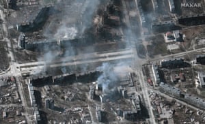 Another view shows buildings on fire in Mariupol, Ukraine