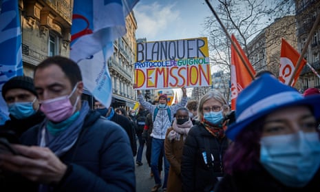 Protesters march through Paris and with a placard that calls for education minister Jean-Michel Blanquer to resign on Thursday.