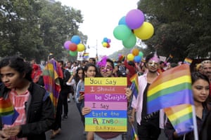 Gay rights activists and their supporters hold colorful balloons and placards as they participate in a gay pride parade in New Delhi