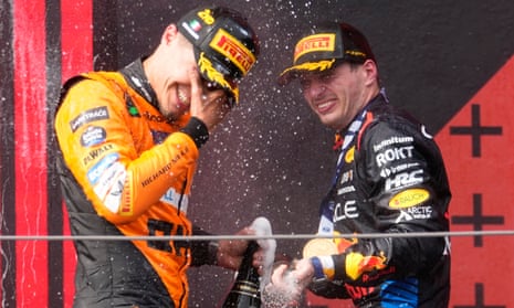 Race-winner Max Verstappen (right) and runner-up Lando Norris celebrate on the podium at Imola.