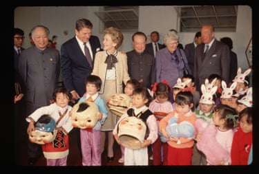 Ronald Reagan and Nancy Reaganstanding behind very small children some with rabbit hats