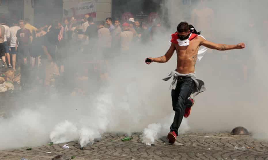 England fan kicks a tear gas canister