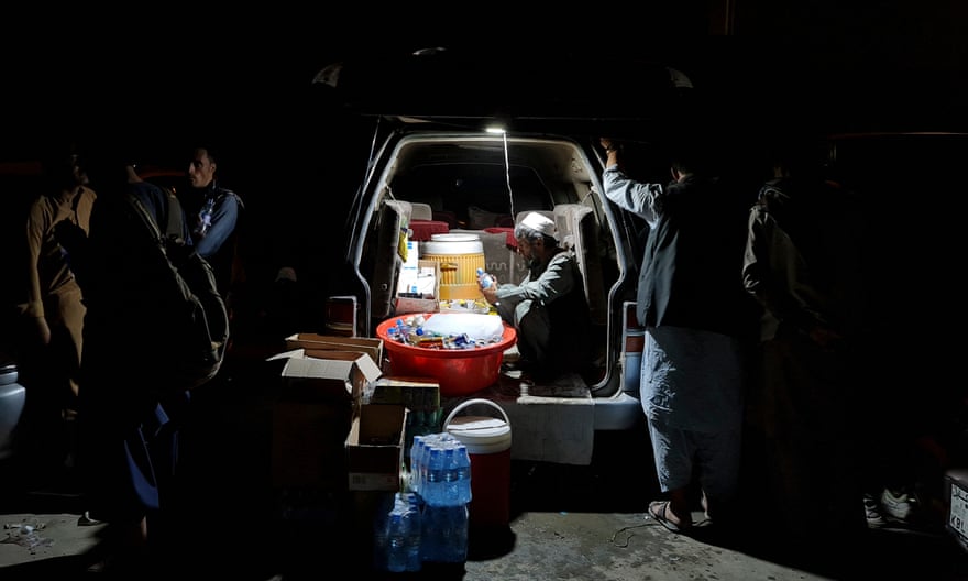 Men surround a van stocked with drinks
