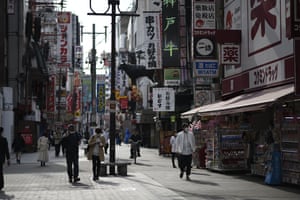People walk in the entertainment district of Dotonbori in Osaka, Japan