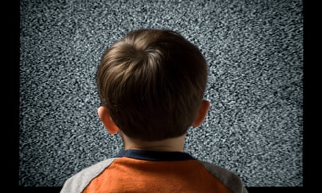 Young Child From Behind Watching Static Television ScreenYoung male child watching television metaphor