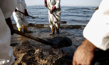 Workers clean a beach in the Athens suburb of Palaio Faliro