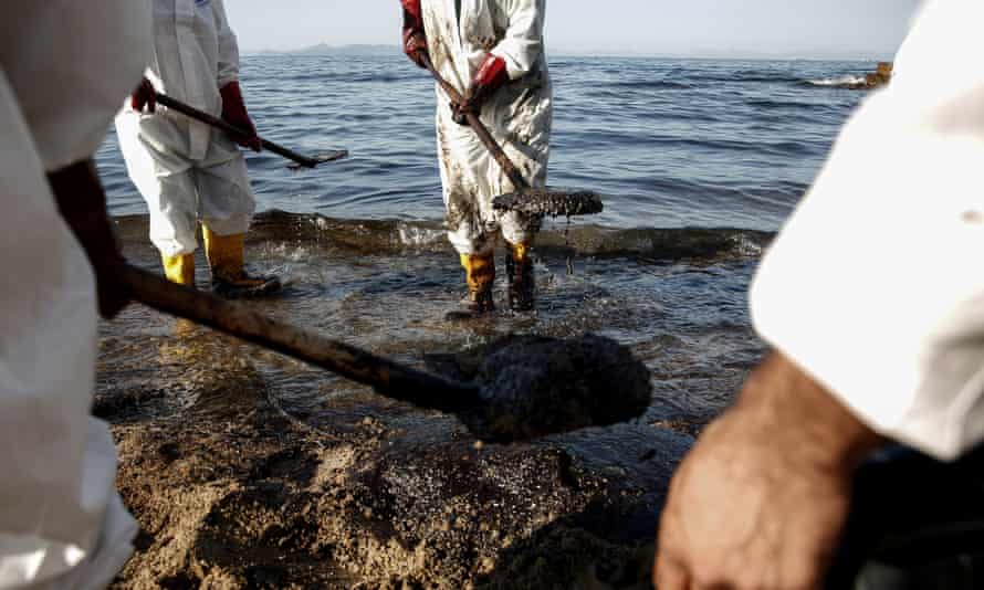 Workers clean a beach in the Athens suburb of Palaio Faliro